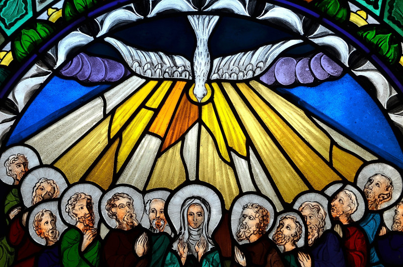 Slupsk, Poland, 2016, stained glass window depicting Pentecost. Stock image.